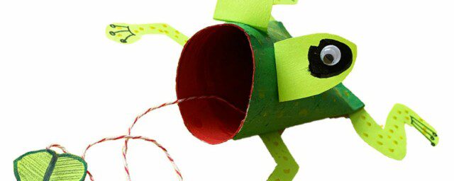 An image of a craft frog made from a toilet roll tube, card, string, green paint and pen.